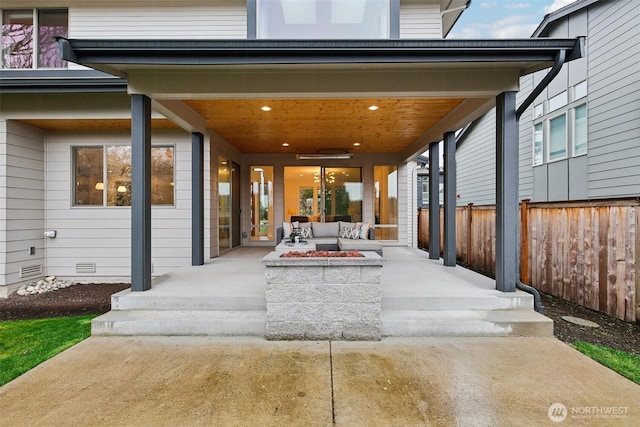 view of patio / terrace featuring an outdoor living space with a fire pit and fence