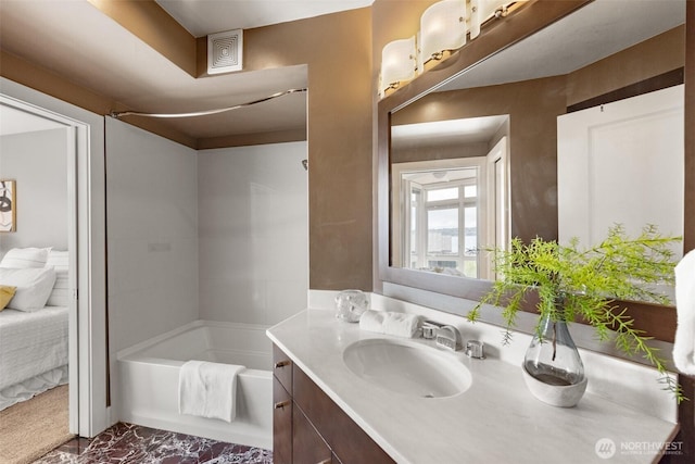 bathroom featuring vanity, a tub, and visible vents