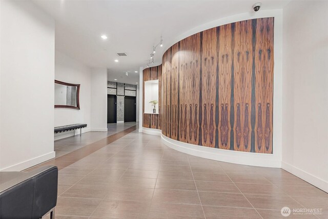 hall with tile patterned flooring, visible vents, recessed lighting, and baseboards