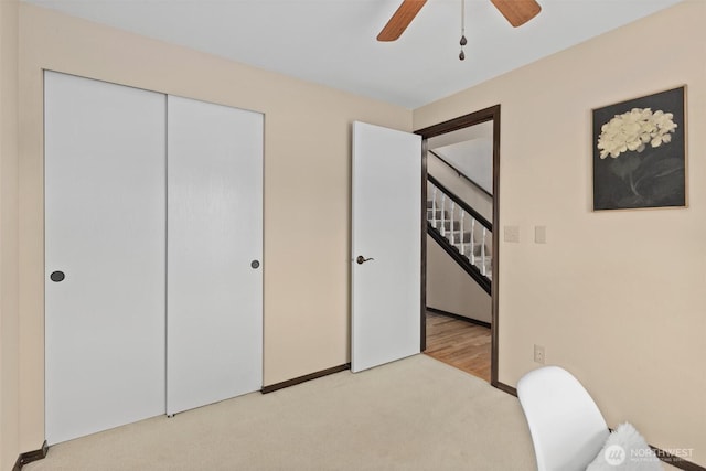 unfurnished bedroom featuring a closet, carpet floors, and ceiling fan