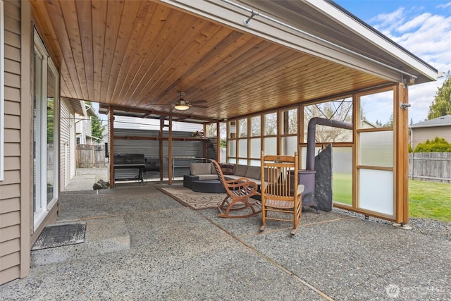 view of patio with a ceiling fan, fence, and grilling area