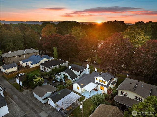 birds eye view of property featuring a residential view and a view of trees