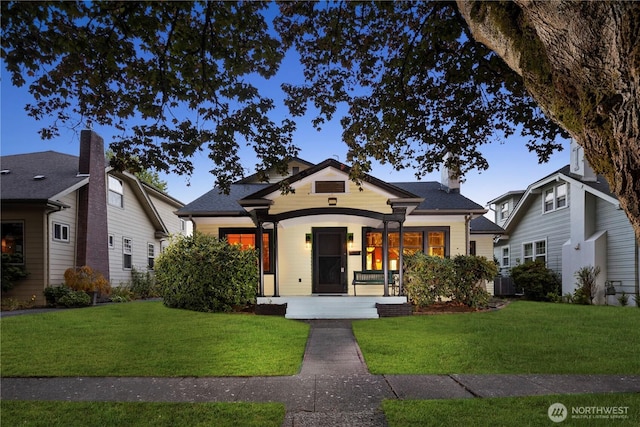 view of front of home featuring a front yard and a porch