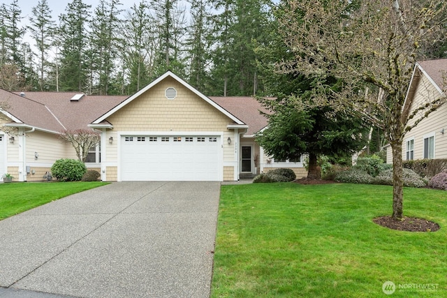 view of front facade featuring driveway, a front lawn, and an attached garage