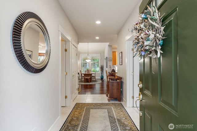 foyer featuring recessed lighting, baseboards, and light tile patterned flooring