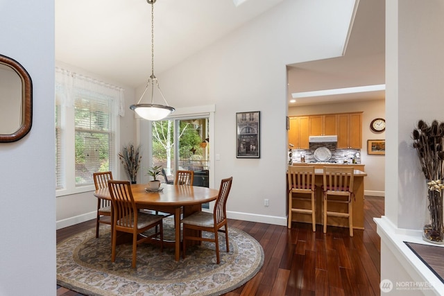 dining area with baseboards, dark wood-style flooring, and high vaulted ceiling