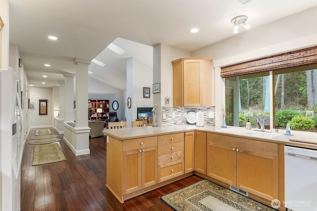 kitchen with visible vents, light brown cabinetry, stainless steel refrigerator with ice dispenser, decorative columns, and dishwasher