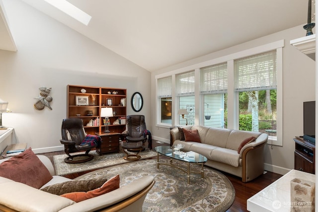 living area featuring baseboards, high vaulted ceiling, a skylight, and dark wood-style flooring