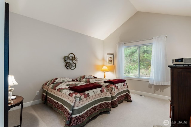 carpeted bedroom featuring visible vents, baseboards, and vaulted ceiling