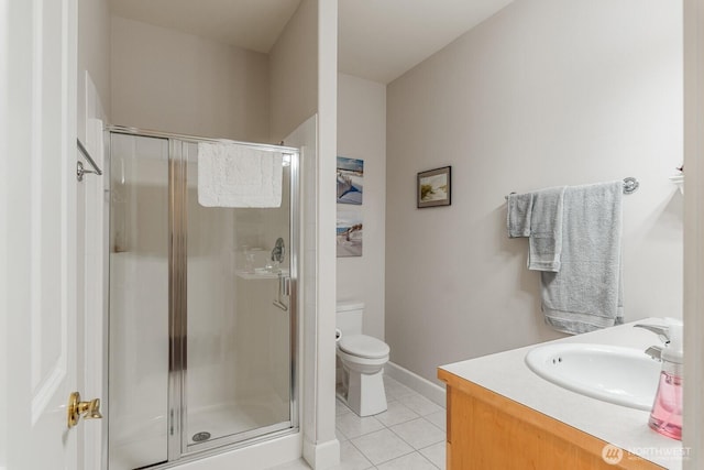 full bath with tile patterned flooring, baseboards, toilet, a stall shower, and vanity