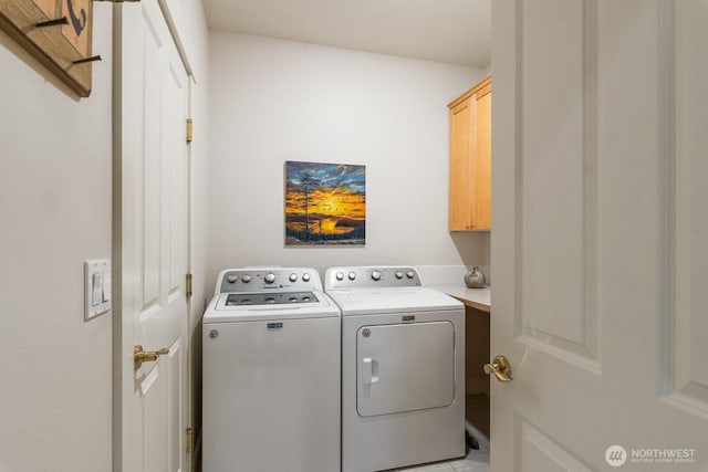 laundry room with cabinet space and washing machine and clothes dryer