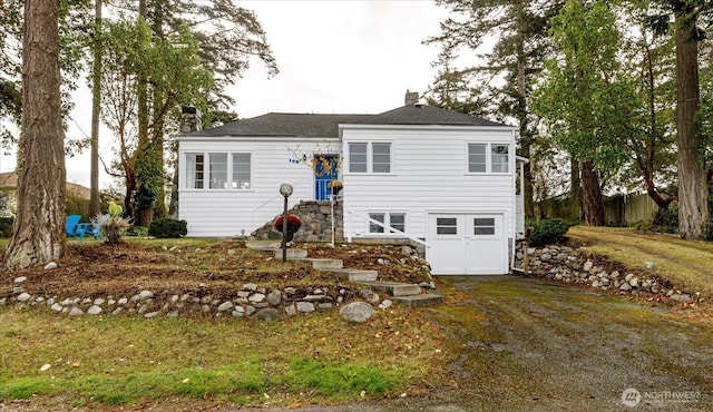 view of front of house with a front lawn and a chimney