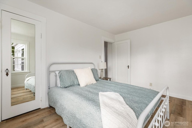 bedroom with wood finished floors and baseboards