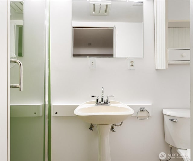 bathroom with visible vents and toilet