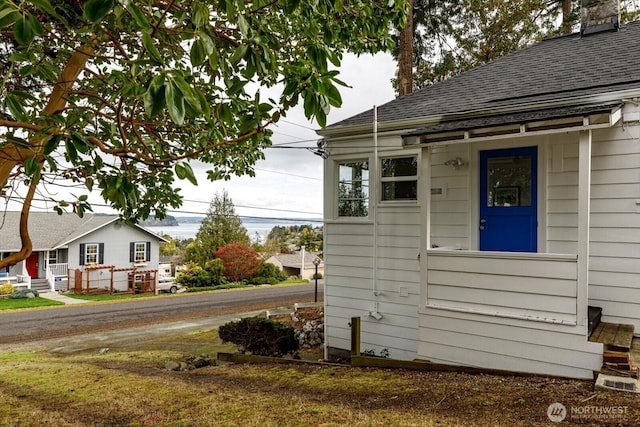 exterior space featuring a shingled roof