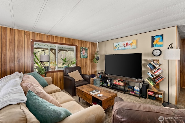 living room with carpet flooring and wood walls