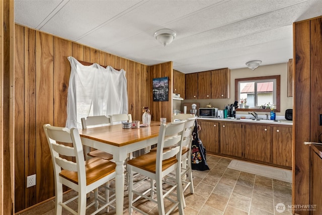 dining space featuring wooden walls