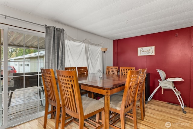 dining area with wood finished floors