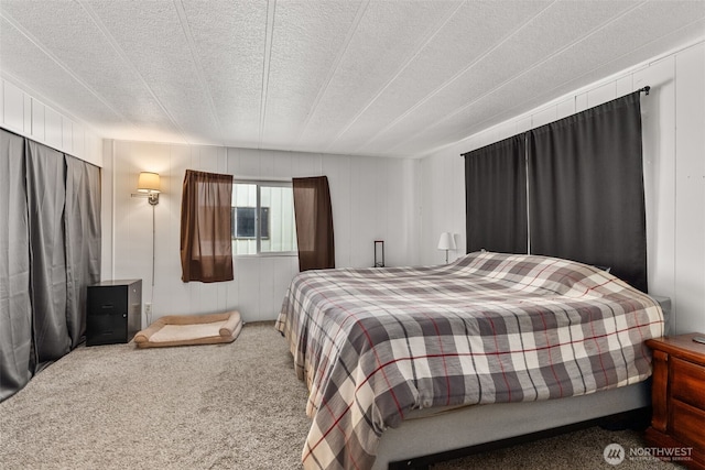 carpeted bedroom featuring a textured ceiling