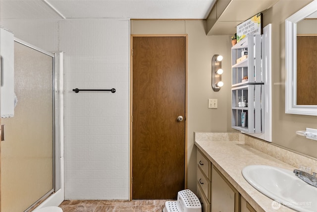 full bath featuring vanity and an enclosed shower