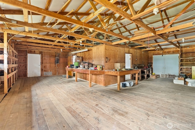 garage featuring a workshop area and wood walls