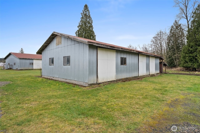 view of pole building with a yard