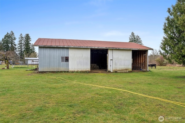 view of pole building with a yard