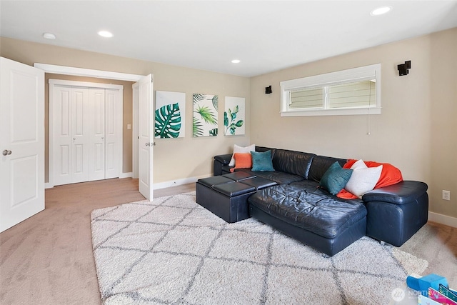 carpeted living area featuring recessed lighting and baseboards