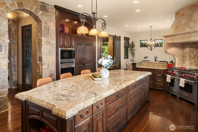 253 E Lake Sammamish Pkwy SE, Sammamish, WA 98074 - kitchen with an inviting chandelier, appliances with stainless steel finishes, premium range hood, dark wood finished floors, and decorative backsplash