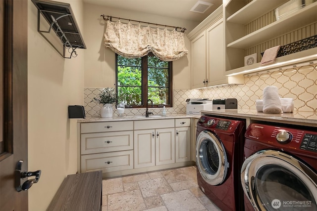 253 E Lake Sammamish Pkwy SE, Sammamish, WA 98074 - clothes washing area with stone tile flooring, visible vents, cabinet space, washer and dryer, and a sink
