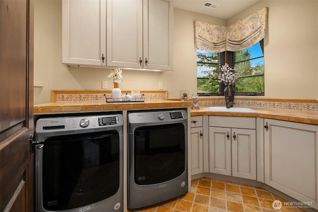 253 E Lake Sammamish Pkwy SE, Sammamish, WA 98074 - laundry room featuring a sink, visible vents, cabinet space, and washer and dryer