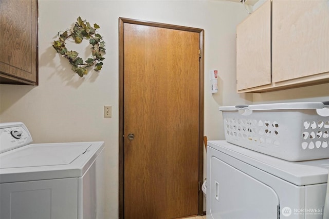 laundry room featuring cabinet space and washing machine and dryer