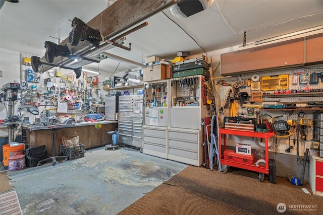 garage with a workshop area and a garage door opener