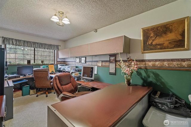 carpeted office space featuring a textured ceiling