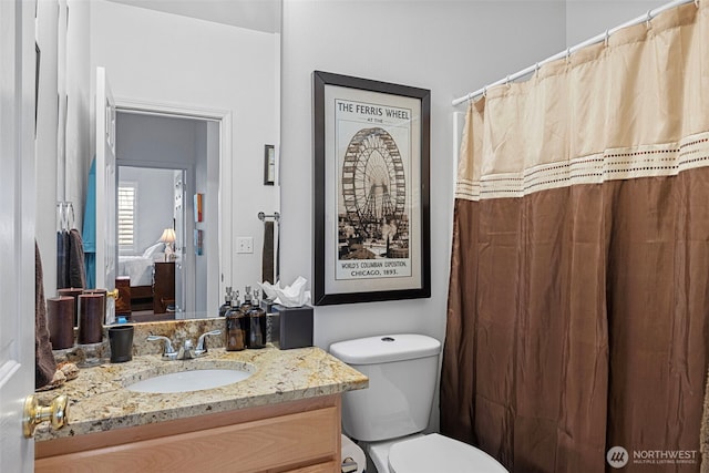 bathroom featuring toilet and vanity