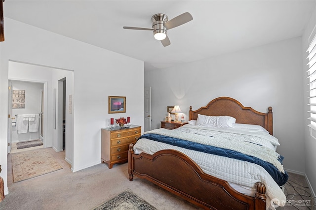 bedroom with light colored carpet, ensuite bath, baseboards, and ceiling fan