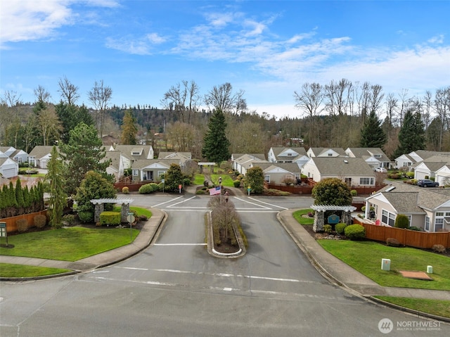 view of road featuring a residential view and curbs