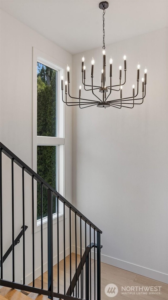 staircase featuring baseboards and wood finished floors