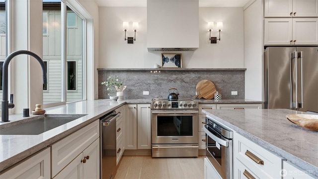 kitchen with a sink, stainless steel appliances, open shelves, and backsplash