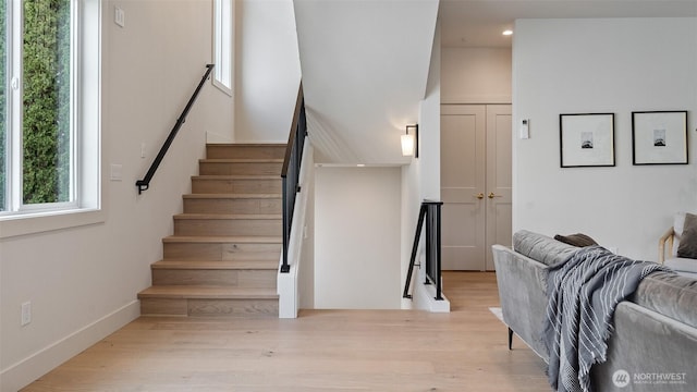 staircase with recessed lighting, wood finished floors, and baseboards