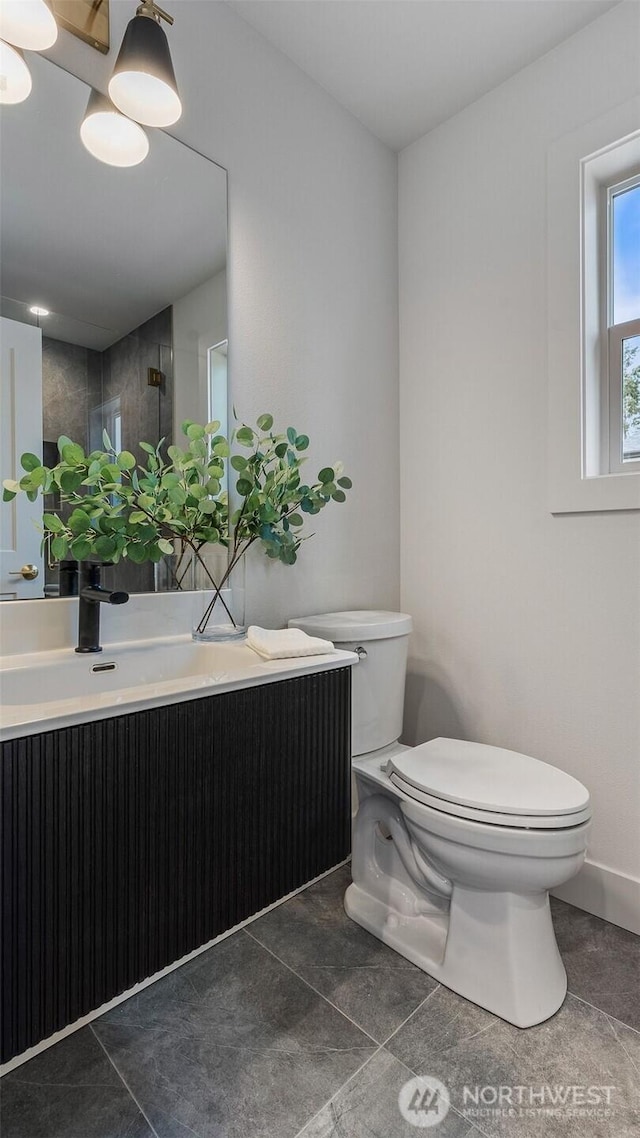 full bath featuring a shower with shower door, toilet, vanity, and tile patterned flooring