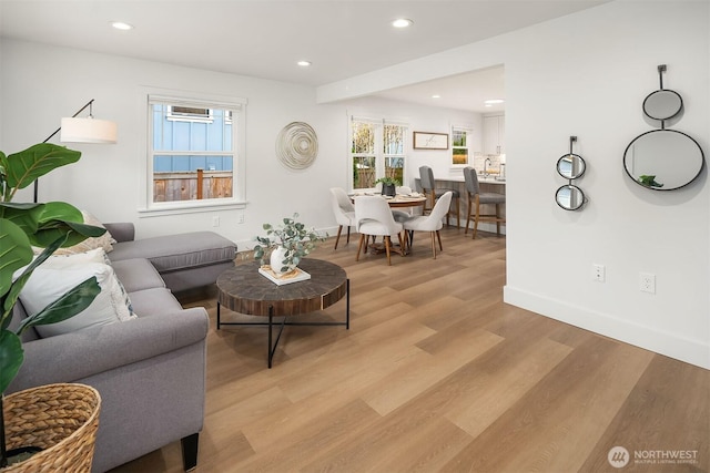 living room with light wood-style flooring, recessed lighting, and baseboards