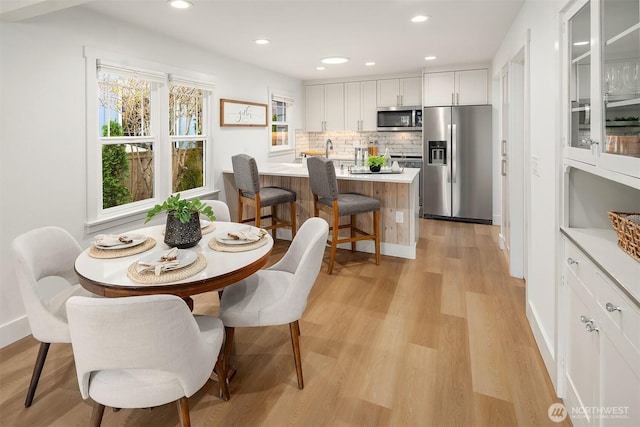 dining room featuring recessed lighting and light wood-style flooring