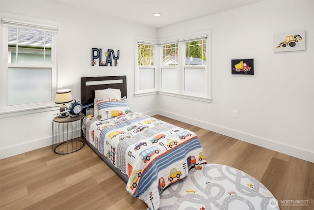 bedroom with recessed lighting, baseboards, and wood finished floors