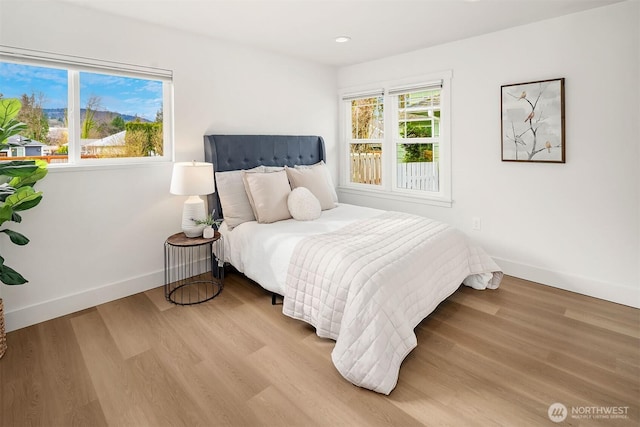 bedroom with recessed lighting, baseboards, and wood finished floors