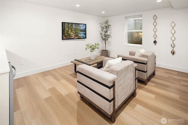 living room featuring recessed lighting, light wood-style flooring, and baseboards