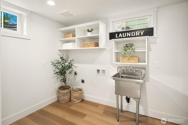 washroom featuring baseboards, laundry area, hookup for a washing machine, wood finished floors, and hookup for an electric dryer