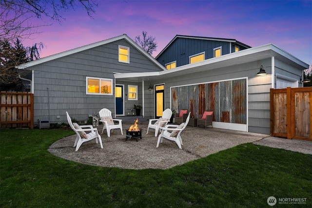 back of house with a patio area, fence, a lawn, and an outdoor fire pit