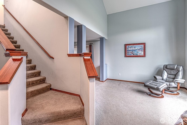 staircase with baseboards and carpet floors