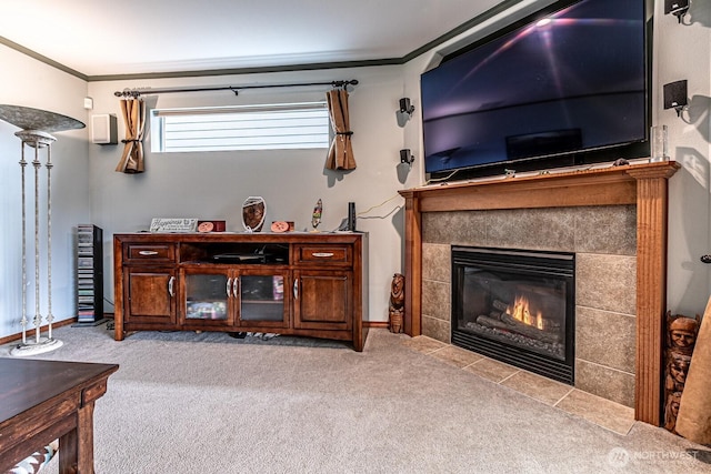 living room with a tiled fireplace, carpet flooring, and ornamental molding